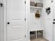 Bright mud room with white shelving, coat hooks, storage baskets, and adjacent doorways at 8703 Jenny Lind St, North Charleston, SC 29406