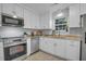 Modern kitchen boasts stainless steel appliances, ample white cabinetry, and granite countertops for a sleek design at 926 Lansing Dr # 926-G, Mount Pleasant, SC 29464