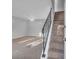 Bright living room with plush carpet and staircase featuring sleek, modern railing at 926 Lansing Dr # 926-G, Mount Pleasant, SC 29464