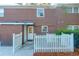 A quaint brick patio with white picket fence offers a charming outdoor space at 926 Lansing Dr # 926-G, Mount Pleasant, SC 29464
