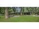 Expansive backyard featuring lush greenery, patio furniture, and a shaded custom built outdoor structure at 960 Savage Road Rd, Charleston, SC 29414