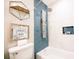 Modern bathroom featuring blue tiled shower, handheld sprayer, and decorative shelving at 960 Savage Road Rd, Charleston, SC 29414