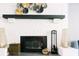 Contemporary fireplace features a black mantel and brick surround with metal accents, creating a cozy atmosphere at 960 Savage Road Rd, Charleston, SC 29414
