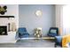 Serene living room with blue accent chairs, fireplace, and gray walls, creating a relaxing and inviting space at 960 Savage Road Rd, Charleston, SC 29414