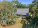 Aerial view of a well-maintained home with mature trees, a manicured lawn, and charming blue double doors at 968 Cummings Cir, Mount Pleasant, SC 29464