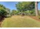 Large backyard featuring a decorative fountain, mature trees, and a well-maintained lawn, perfect for outdoor entertaining at 968 Cummings Cir, Mount Pleasant, SC 29464