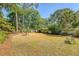 Serene backyard featuring a decorative fountain, mature trees, and manicured landscaping for a private outdoor oasis at 968 Cummings Cir, Mount Pleasant, SC 29464