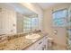 Bright bathroom features a granite countertop, white cabinetry, and a shower with a striped curtain at 968 Cummings Cir, Mount Pleasant, SC 29464