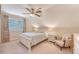 Cozy bedroom showcases a ceiling fan, a large window, and a comfortable sitting chair at 968 Cummings Cir, Mount Pleasant, SC 29464