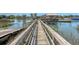 Inviting boardwalk view showcasing a weathered wooden path with railing and waterfront buildings in the distance, perfect for a walk at 968 Cummings Cir, Mount Pleasant, SC 29464