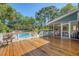 Wooden deck leads to a screened porch overlooking a sparkling swimming pool at 968 Cummings Cir, Mount Pleasant, SC 29464