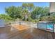 Lovely wooden deck overlooks the refreshing in-ground pool and beautifully landscaped backyard at 968 Cummings Cir, Mount Pleasant, SC 29464