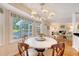 Bright dining area with a chandelier and adjacent screened porch and living room, with wood floors at 968 Cummings Cir, Mount Pleasant, SC 29464