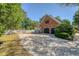 Spacious driveway leading to a brick garage with black doors and a charming adjacent blue entry door at 968 Cummings Cir, Mount Pleasant, SC 29464