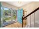 Welcoming entryway with a vibrant blue door, wood floors, and staircase leading to the upper level at 968 Cummings Cir, Mount Pleasant, SC 29464