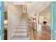 Bright foyer with staircase and hardwood floors, offering a glimpse into the open-concept living spaces at 968 Cummings Cir, Mount Pleasant, SC 29464