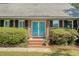 Charming home exterior with brick facade, bright blue front door, and manicured landscaping enhancing curb appeal at 968 Cummings Cir, Mount Pleasant, SC 29464