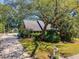 Beautifully landscaped property with mature trees, shrubs, and colorful flowers enhancing the home's curb appeal at 968 Cummings Cir, Mount Pleasant, SC 29464