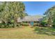 Charming single-story brick home with a lush, landscaped front yard and inviting blue double doors at 968 Cummings Cir, Mount Pleasant, SC 29464