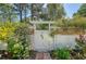 Charming garden gate with climbing flowers and a decorative lattice fence creating a serene outdoor space at 968 Cummings Cir, Mount Pleasant, SC 29464