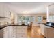 Open kitchen with black countertops overlooking an eating area with backyard views at 968 Cummings Cir, Mount Pleasant, SC 29464
