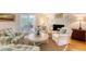 Bright, airy living room with fireplace, screened-in porch access, and cozy seating arrangement at 968 Cummings Cir, Mount Pleasant, SC 29464