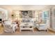 Bright living room featuring neutral furniture, shutters, light hardwood floors and artwork above the sofa at 968 Cummings Cir, Mount Pleasant, SC 29464