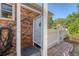 Charming outdoor shower featuring brick surround and white privacy door on a brick patio near a manicured lawn at 968 Cummings Cir, Mount Pleasant, SC 29464