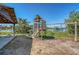 Community playground by the water features a play structure and swings for enjoying outdoor activities at 968 Cummings Cir, Mount Pleasant, SC 29464