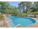 In-ground pool with easy-access steps, and lush landscaping around a secure, white fenced yard at 968 Cummings Cir, Mount Pleasant, SC 29464
