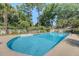 Clear in-ground pool featuring lush greenery, mature trees, and a secure fenced perimeter at 968 Cummings Cir, Mount Pleasant, SC 29464