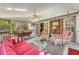 Bright porch boasts comfortable seating, a dining area, and an eye-catching brick accent wall at 968 Cummings Cir, Mount Pleasant, SC 29464