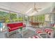 Relaxing porch features wicker furniture, ceiling fan, and views of the backyard pool at 968 Cummings Cir, Mount Pleasant, SC 29464