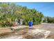 Outdoor wash station with concrete slab, spigots, and adjacent parking on a gravel road with greenery at 968 Cummings Cir, Mount Pleasant, SC 29464