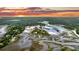 Amazing aerial view of waterfront property featuring scenic waterways, lush greenery and sunset at 000 Remington Trl, Johns Island, SC 29455