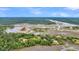 Panoramic aerial shot reveals the winding river, lush trees, and coastal charm at 000 Remington Trl, Johns Island, SC 29455