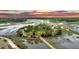 Expansive aerial view of a waterfront property with lush landscaping and private access to the waterway at 000 Remington Trl, Johns Island, SC 29455
