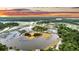 Stunning aerial view showcasing the waterfront property with lush greenery and scenic sunset at 000 Remington Trl, Johns Island, SC 29455