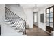 Elegant foyer with hardwood floors, modern staircase, and ample natural light at 000 Remington Trl, Johns Island, SC 29455