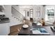 Inviting living room featuring hardwood floors, natural light, and a modern staircase with iron railings at 000 Remington Trl, Johns Island, SC 29455
