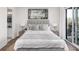 Cozy bedroom boasts a plush bed, soft lighting, and access to an outdoor balcony with scenic views at 000 Remington Trl, Johns Island, SC 29455