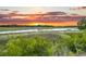 Scenic marsh view with vibrant greenery and a colorful sunset backdrop at 000 Remington Trl, Johns Island, SC 29455