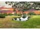 Tranquil pond view with lush green grass and mature trees, reflecting the sunset sky at 000 Remington Trl, Johns Island, SC 29455