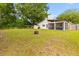 Expansive backyard featuring mature trees, fire pit, and partial view of the home's exterior at 1024 Willowood Ave, Goose Creek, SC 29445