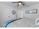 Bright bedroom featuring a queen bed with patterned linens, ceiling fan, and white walls at 1024 Willowood Ave, Goose Creek, SC 29445