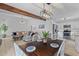 Open-concept dining area featuring a dark wood table, white chairs, and a view of the living room and kitchen at 1024 Willowood Ave, Goose Creek, SC 29445