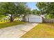 Front exterior of a charming single-story home featuring a long driveway, garage and a well-manicured lawn at 1024 Willowood Ave, Goose Creek, SC 29445