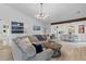 Open concept living room featuring a sectional sofa, wood beam and access to the dining room and kitchen at 1024 Willowood Ave, Goose Creek, SC 29445