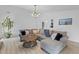 Cozy living room with comfortable sectional sofa, round wood coffee table and modern light fixture at 1024 Willowood Ave, Goose Creek, SC 29445