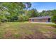 Expansive backyard showcasing a well-maintained lawn, mature trees, and a brick home exterior at 106 Newington Rd, Summerville, SC 29485